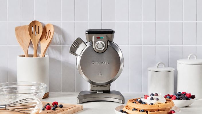 waffle maker with waffles and berries