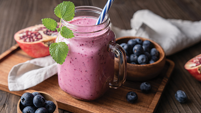 berry smoothie with bowl of blueberries